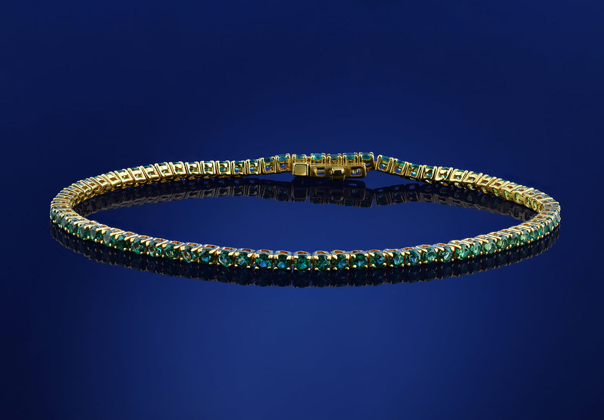 Emerald gemstone tennis bracelet in yellow gold